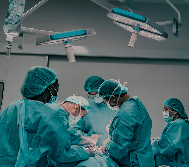 6 medical staff working on a patient in an operating room